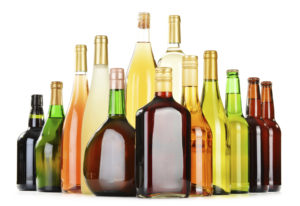 Bottles of assorted alcoholic beverages isolated on white